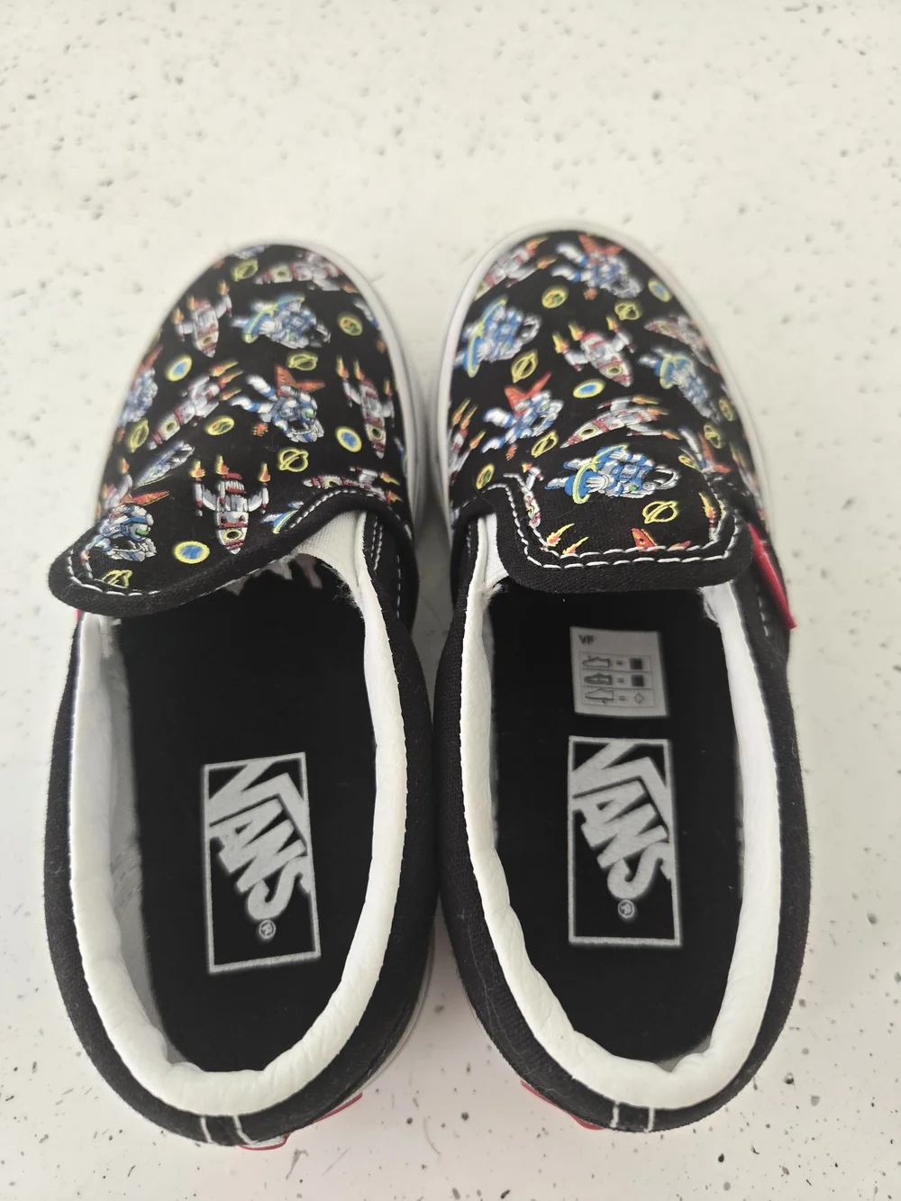 Vans Kids Slip-On Sneakers in Black with Multicolor Robot Print